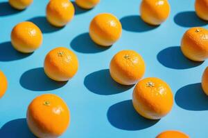 A pattern of whole mandarin oranges on a blue background. photo
