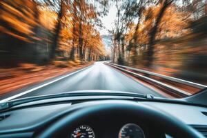 A car driving through an autumn forest. photo