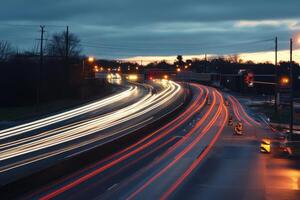 A long exposure shot of a highway at night with streaks of light from passing cars. photo