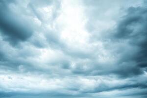 A low angle view of a cloudy sky with light shining through the clouds. photo