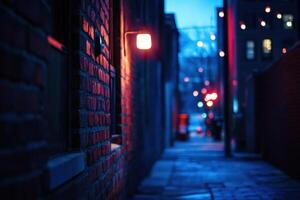 A narrow brick alleyway is illuminated by a single streetlamp, with blurred lights in the distance. photo
