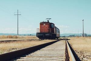 A red vintage electric train locomotive stands on railroad tracks. photo