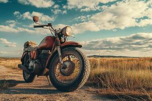 A rusty motorcycle sits in a field of tall grass. photo