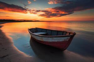 A small boat sits on the shore at sunset. photo