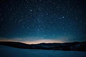 A starry night sky over snow-covered mountains. photo