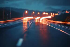 A wet highway at night with blurry lights in the distance. photo