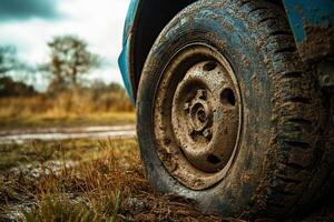 A close up of a car tire on a muddy road photo