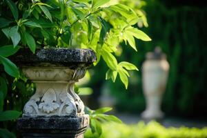 Close-up of an ornate stone pillar in a lush garden. photo
