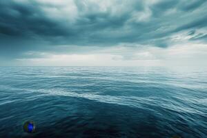 Dark storm clouds over vast blue ocean. photo