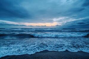 Dramatic sunset over the ocean with waves crashing on the shore. photo