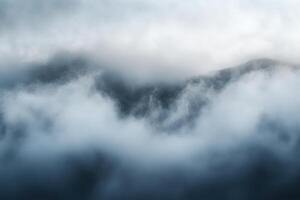 Misty Mountain Peaks Hidden in Clouds. photo