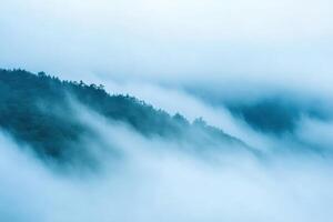 Misty mountain range with soft, ethereal clouds. photo