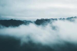 Misty mountains with low clouds, viewed from above. photo