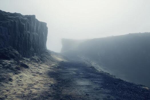 A path leads to a cliff in the fog photo