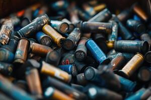 A close-up of a pile of spent shotgun shells, with a variety of colors and finishes. photo