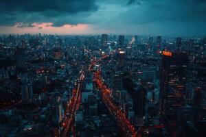A panoramic view of Tokyo at dusk, with the city's skyline illuminated by streetlights and traffic. photo