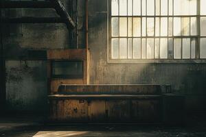 A sunbeam illuminates an old rusty workbench in a derelict factory. photo