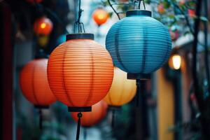 Colorful lanterns hang in a row, illuminating a street. photo