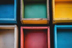 Colorful wooden boxes in a grid pattern, showcasing different colors and textures. photo