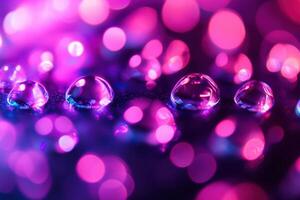 Water drops on a surface with a purple and pink bokeh background. photo