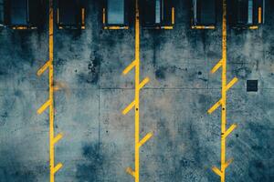 Empty parking spaces with yellow lines painted on a concrete surface. photo