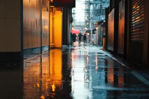 Wet, narrow alleyway with blurry figures walking in the rain. photo