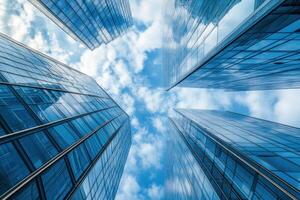 Low angle view of modern skyscrapers reaching for the blue sky. photo