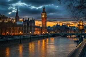 London's iconic Big Ben and Houses of Parliament at dusk, reflected in the River Thames. photo