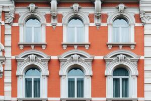 Close-up of ornate windows on a red brick building. photo