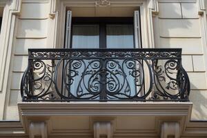 Ornate wrought iron balcony with window. photo