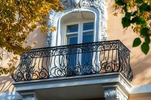 Ornate balcony with iron railing and window. photo