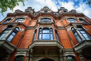 Red brick Victorian mansion with intricate architectural details. photo