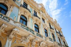 A low angle view of a historic building with intricate details and ornate balconies. photo