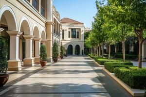 A wide, paved pathway lined with lush greenery and arched doorways leads to a building in the distance. photo