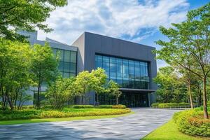 Modern building with glass facade and landscaped grounds. photo