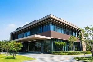Modern office building with glass facade and green landscaping. photo