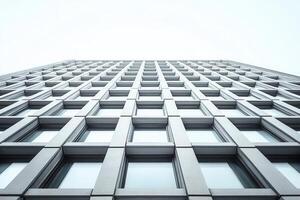 Low angle view of a modern building with repetitive windows. photo