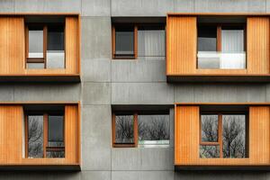 Modern building facade with wooden window frames. photo
