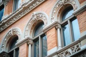 Ornate brick building facade with arched windows. photo