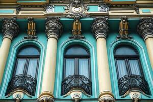 Ornate facade with arched windows and columns. photo