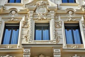 Ornate facade with three windows and intricate carvings. photo