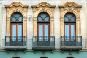 Three arched windows with balconies on a building facade. photo