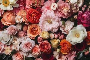 A colorful and vibrant floral background featuring an assortment of roses, peonies, and other blooms in various shades of pink, red, orange, and white. photo