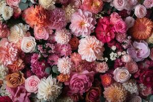 A vibrant floral background with roses, carnations, dahlias, and other blossoms in a mix of pink, red, and white hues. photo