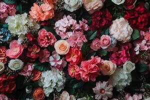 A vibrant wall of colorful artificial flowers. photo