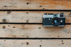 Vintage camera hanging on rustic wood. photo
