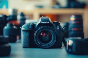 A DSLR camera with a lens on a table with other camera equipment. photo