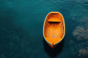 A small, wooden boat floats in calm blue water. photo