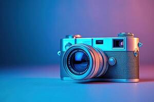 Vintage silver camera on a table with blue and pink lighting. photo