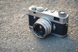 Vintage Silver Rangefinder Camera on Concrete. photo